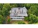 Gorgeous home with solar panels nestled amongst the trees with a stone chimney and spacious covered porches at 2216 Trammel Rd, Cumming, GA 30041