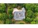Stunning aerial view of home with grey shingles, private driveway, lush trees and manicured lawn at 2216 Trammel Rd, Cumming, GA 30041