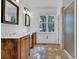 Bright bathroom featuring double sinks, framed mirrors, wood floors, and a glass shower at 2216 Trammel Rd, Cumming, GA 30041