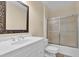 Bright bathroom with a white vanity, framed mirror, and glass shower doors at 2216 Trammel Rd, Cumming, GA 30041