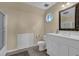 Bright bathroom featuring a white vanity, shower and bathtub, toilet, and a tiled floor at 2216 Trammel Rd, Cumming, GA 30041