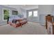 Bright bedroom with pale blue walls, large windows, and hardwood dresser at 2216 Trammel Rd, Cumming, GA 30041