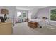 Cozy bedroom with soft lilac walls, carpet, and natural light from two windows at 2216 Trammel Rd, Cumming, GA 30041