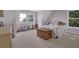 Charming bedroom with carpet floors, comfortable bed, built-in shelves, and windows offering views at 2216 Trammel Rd, Cumming, GA 30041