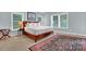 Bright bedroom with natural light, white linen bedding, and decorative rug at 2216 Trammel Rd, Cumming, GA 30041