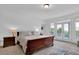 Well-lit bedroom featuring a beautiful view through the French doors and tasteful furnishings at 2216 Trammel Rd, Cumming, GA 30041