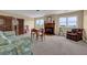 Versatile bonus room featuring a fireplace, comfortable seating, and windows offering scenic views at 2216 Trammel Rd, Cumming, GA 30041