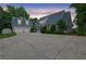 Charming home with a long driveway, lush landscaping, and a detached two-car garage at 2216 Trammel Rd, Cumming, GA 30041