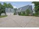 Beautiful home exterior featuring a long driveway, two-car garage, and lush landscaping at 2216 Trammel Rd, Cumming, GA 30041