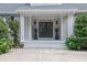 Charming front entrance featuring a double door, elegant lighting, and beautiful landscaping at 2216 Trammel Rd, Cumming, GA 30041