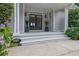 Elegant front entrance with double doors, decorative plants, and stylish lighting fixtures at 2216 Trammel Rd, Cumming, GA 30041