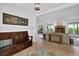 Open-concept living room with dark wood floors, neutral furniture, and natural light at 2216 Trammel Rd, Cumming, GA 30041