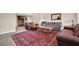 Comfortable living room with large rug and leather couches for entertaining at 2216 Trammel Rd, Cumming, GA 30041