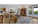 Inviting living room with a stone fireplace, comfortable seating, hardwood floors, and access to outdoor area at 2216 Trammel Rd, Cumming, GA 30041