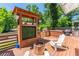 Relaxing backyard deck with a wooden hot tub, stainless steel gas grill, and inviting Adirondack chairs at 2405 Hillside Ave, Decatur, GA 30032