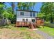 Two-story home featuring a spacious deck, landscaped backyard, and charming stone pathway to the back at 2405 Hillside Ave, Decatur, GA 30032
