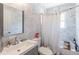Bright bathroom featuring marble tile, updated vanity and a shower-tub combination at 2405 Hillside Ave, Decatur, GA 30032