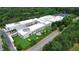 Aerial view of a large school building with playground and parking lot, surrounded by lush greenery and trees at 2405 Hillside Ave, Decatur, GA 30032