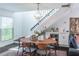 Bright dining area features modern lighting, bar with wine cooler, and staircase at 2405 Hillside Ave, Decatur, GA 30032