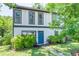 Charming two-story home featuring a bright blue front door and lush landscaping at 2405 Hillside Ave, Decatur, GA 30032