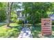 Charming two-story home featuring a bright blue front door, and address on a wooded post at 2405 Hillside Ave, Decatur, GA 30032