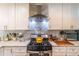 Beautiful kitchen features white cabinets, marble countertops, and modern stainless steel appliances at 2405 Hillside Ave, Decatur, GA 30032