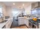 Modern kitchen boasts stainless steel appliances and marble countertops, open to living spaces at 2405 Hillside Ave, Decatur, GA 30032
