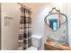 Stylish powder room featuring modern fixtures, unique mirror, and a decorative shower curtain at 2405 Hillside Ave, Decatur, GA 30032