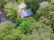 Aerial view of the home surrounded by mature trees and showing back deck and backyard at 3919 Valley Brook Rd, Snellville, GA 30039