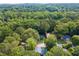 Aerial view of homes surrounded by lush mature trees in a quiet neighborhood at 3919 Valley Brook Rd, Snellville, GA 30039