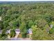 Distant aerial view of the home surrounded by lush green trees at 3919 Valley Brook Rd, Snellville, GA 30039