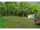 Spacious backyard with lush green grass, mature trees, and shed at 3919 Valley Brook Rd, Snellville, GA 30039