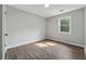 Bright bedroom featuring natural light, neutral walls, and wood-look flooring at 3919 Valley Brook Rd, Snellville, GA 30039