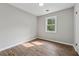 Cozy bedroom with natural light, neutral walls, and wood-look flooring at 3919 Valley Brook Rd, Snellville, GA 30039