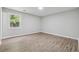 Spacious bedroom featuring natural light, neutral walls, and wood-look flooring at 3919 Valley Brook Rd, Snellville, GA 30039