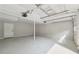 Bright garage with white walls, painted floors, garage door, and access door to inside at 3919 Valley Brook Rd, Snellville, GA 30039
