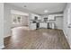 Open concept kitchen and living room with stainless appliances and white cabinets at 3919 Valley Brook Rd, Snellville, GA 30039