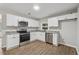 Well-lit kitchen boasts stainless steel appliances, sleek white cabinets, and modern finishes at 3919 Valley Brook Rd, Snellville, GA 30039