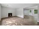 Bright open-concept living room with wood-look flooring and fireplace at 3919 Valley Brook Rd, Snellville, GA 30039