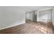Large open living room with wood-look flooring and staircase access at 3919 Valley Brook Rd, Snellville, GA 30039