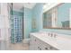 Stylish bathroom featuring a white vanity with stone countertops and a shower with patterned curtains at 8643 Ellard Dr, Alpharetta, GA 30022