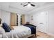 Well-lit bedroom featuring neutral tones, an ceiling fan, and convenient closet space at 8643 Ellard Dr, Alpharetta, GA 30022