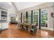 A dining room with hardwood floors, large windows, and vaulted ceilings at 8643 Ellard Dr, Alpharetta, GA 30022