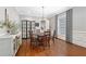 Spacious dining room with hardwood floors, a chandelier, wainscoting and large windows offers a sophisticated dining experience at 8643 Ellard Dr, Alpharetta, GA 30022