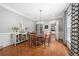 Well-lit dining room featuring hardwood floors, a modern chandelier, and elegant wainscoting, perfect for gatherings at 8643 Ellard Dr, Alpharetta, GA 30022