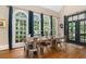 A dining room with hardwood floors and a large window and door with a lovely view at 8643 Ellard Dr, Alpharetta, GA 30022