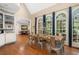 A well-lit dining room featuring hardwood floors, large windows, and vaulted ceilings at 8643 Ellard Dr, Alpharetta, GA 30022