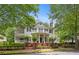 Elegant two-story home with white exterior, black shutters, and meticulously landscaped front yard at 8643 Ellard Dr, Alpharetta, GA 30022