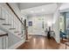 Inviting foyer with hardwood floors, staircase, and elegant decor creating a warm entrance at 8643 Ellard Dr, Alpharetta, GA 30022