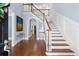 Grand foyer with hardwood floors, a staircase, and elegant wainscoting welcomes guests into this beautiful home at 8643 Ellard Dr, Alpharetta, GA 30022